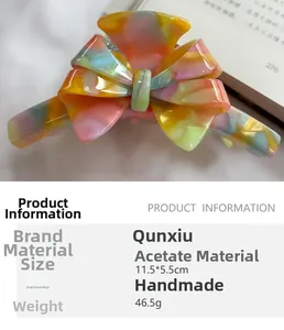 Detail of marble acetate bow hair claw clip showing dimensions 11.5cm by 5.5cm