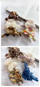 Detail showing various acetate bow hair claws with tortoise and pearlescent patterns