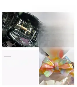 Detail view of large French acetate hair claw clips with premium metallic spring structure