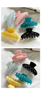 Detailed tile display of star and moon rhinestone acetate hair claws in five colors