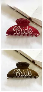 Detailed view of resin hair claws featuring pearl Bride lettering in burgundy and dark brown