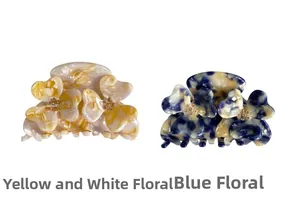 Detail view of acetate flower hair claws with rhinestone centers in yellow and blue floral