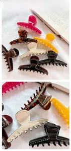 Detail view of large acetate hair claws with rhinestone accents in assorted vintage colors