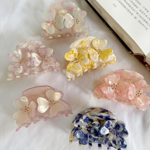 Elegant floral acetate hair claws set in assorted colors with a marble finish