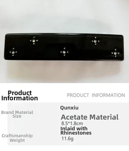 Detail view of a black acetate hair clip with star rhinestones and product dimensions