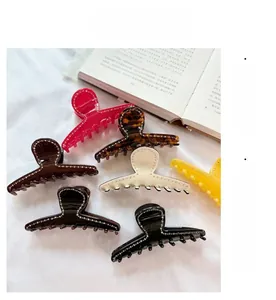 Close-up of assorted rhinestone acetate hair claws in various colors and patterns