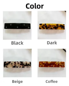 Detail view of acetate hair clips with rhinestones in black and tortoiseshell patterns