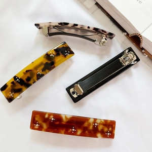 French rhinestone hair clips set with tortoiseshell and marble patterns in 45-degree view