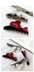 Detailed view of acetic acid butterfly hair clips with sparkling rhinestone embellishments