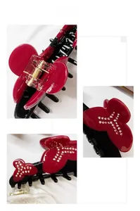 Detail view of large resin hair claw with red crystal bow and durable metal spring