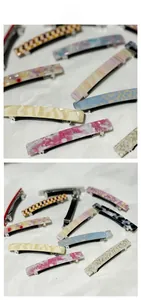 Detail view of acetate spring hair clips with marble patterns and silver metal base