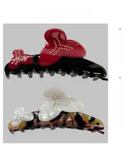 Detail of floral hair claws with rhinestones on tortoise shell and black resin bases