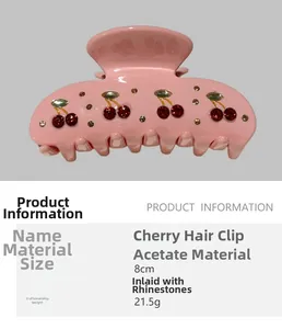Detail of pink acetate hair claw clip featuring red rhinestone cherry pattern accents