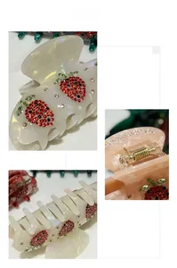 Close-up of strawberry hair claw with red rhinestones on pearlescent acetate material