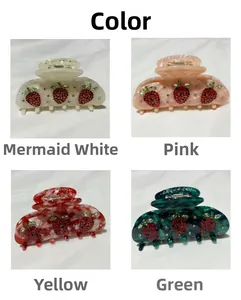 Detail view of strawberry acetate hair claws with rhinestones in white, pink, red, and green