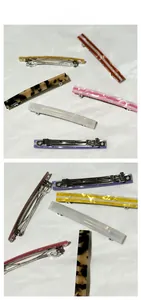 Close-up of assorted rectangle acrylic spring hair clips with striped patterns