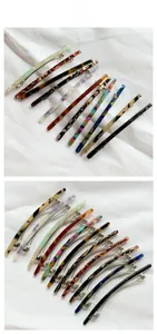 Detailed tile display of 12-piece tortoiseshell acetate spring hair clips with metal base