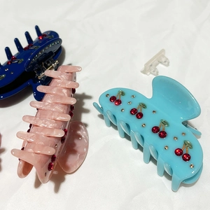 Elegant cherry rhinestone hair claw set in navy, pink, and sky blue resin finishes