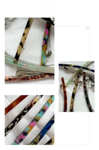 Close-up of tortoise shell and marble acetate spring hair clips with silver metal fasteners