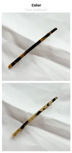 Detailed view of long tortoiseshell acetate spring hair clips on white fabric