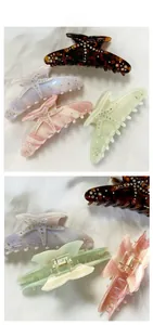Detailed views of starfish hair claws in tortoise shell, purple, pink and green with rhinestones