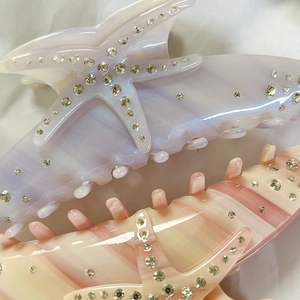 Elegant starfish-shaped acetate hair claw clip with rhinestones in pearl pink and purple