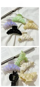 Macro detail of high-quality acetate hair claws with durable metal springs and pearly finish