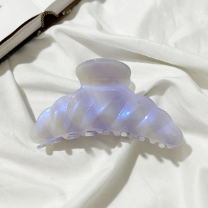 Detail of lavender pearlescent acetate hair claw clip with a twisted wave texture design