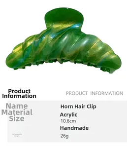Detail view of 10.6cm acrylic hair claw clip with green and gold marbling texture