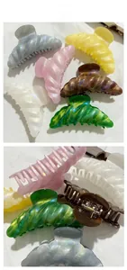 Detail view of large marble texture shark hair clips in six assorted pastel colors
