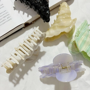 French style acetate croissant hair claws in multiple marble textures for thick hair