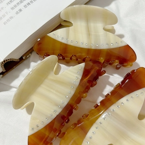 French luxury acetate hair claw clip with rhinestones in cream and amber tortoiseshell