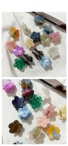 Detailed view of colorful mini flower hair claws with glossy acetate marble texture