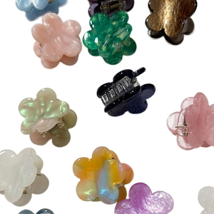 Mini floral hair claws in vibrant assorted colors with a glossy resin finish for styling