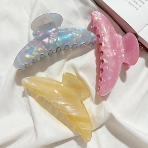 Elegant French crescent hair claws in pearlescent purple, pink, and amber finishes