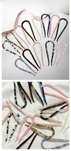 Close-up of acetate U-shaped hair pins in various patterns like tortoiseshell and marble