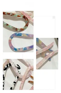 Detail showing acetate U-shaped hair pins with marble patterns and tortoiseshell textures