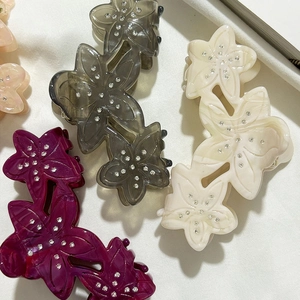 Floral acetate hair claw clips with rhinestones in grey, cream, and magenta