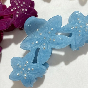Acetate flower hair claw clip with rhinestones in light blue and magenta styles