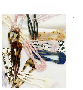 Detailed close-up showing various acetate U-shaped hair pins with diverse marble patterns