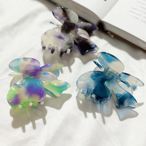 Elegant butterfly hair claws set in acetate marble texture for French style updos