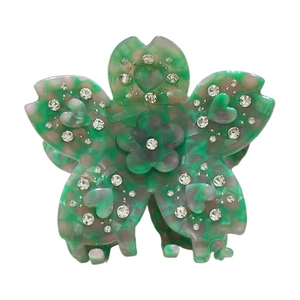 Pince à cheveux fleur en acétate avec motif marbré coloré et strass brillants