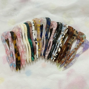 U-shaped acetate hair pins in multiple colors like tortoiseshell and marble patterns