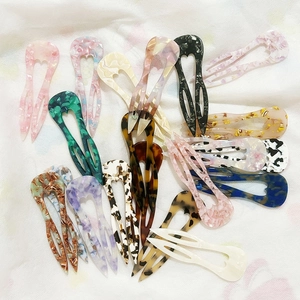 U-shaped acetate hair pins in various patterns like marble and tortoiseshell