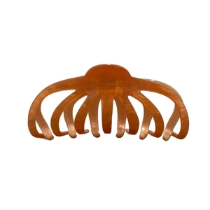 Elegant amber acetate octopus claw hair clip with subtle gold glitter on white backdrop