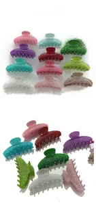 Detail showing various colors of glitter acrylic hair claw clips with matte finish