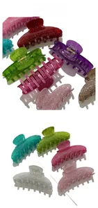 Detail showing glitter acrylic hair claw clips in various vibrant colors with metal springs