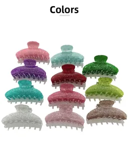 Macro shot of large glittery acrylic shark hair claws in ten various vibrant colors