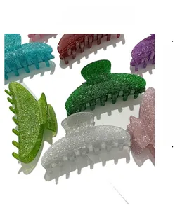 Close-up of glitter acrylic hair claw clips in various bright colors for women