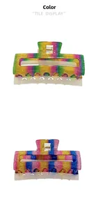 Detail view of large rainbow shark hair clips with glitter coating and tile display